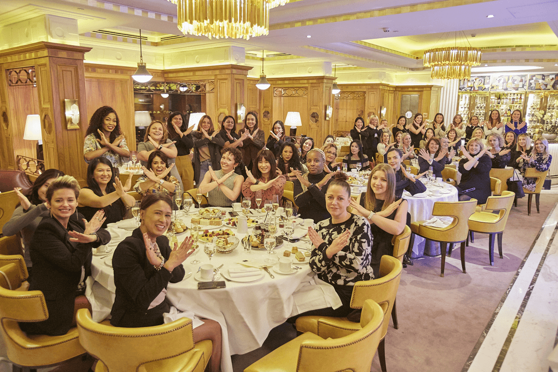 Women making a cross with their arms.