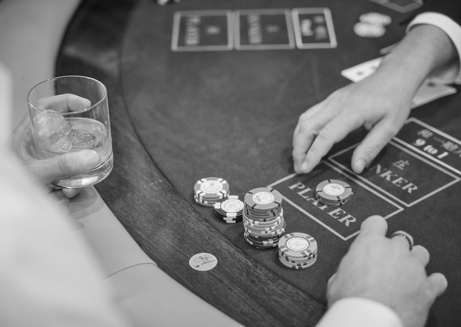 A card dealer moving chips on a table