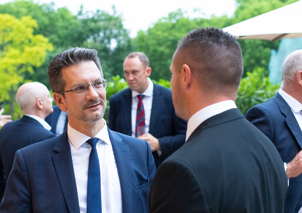 Steve Baker speaking to someone at a charity event.