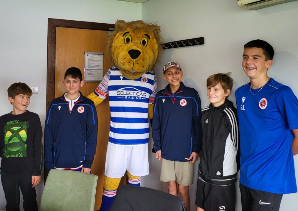 Kids smiling for a photo with the Reading FC mascot