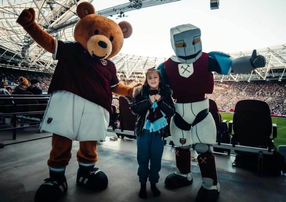West Ham mascots posing with a child