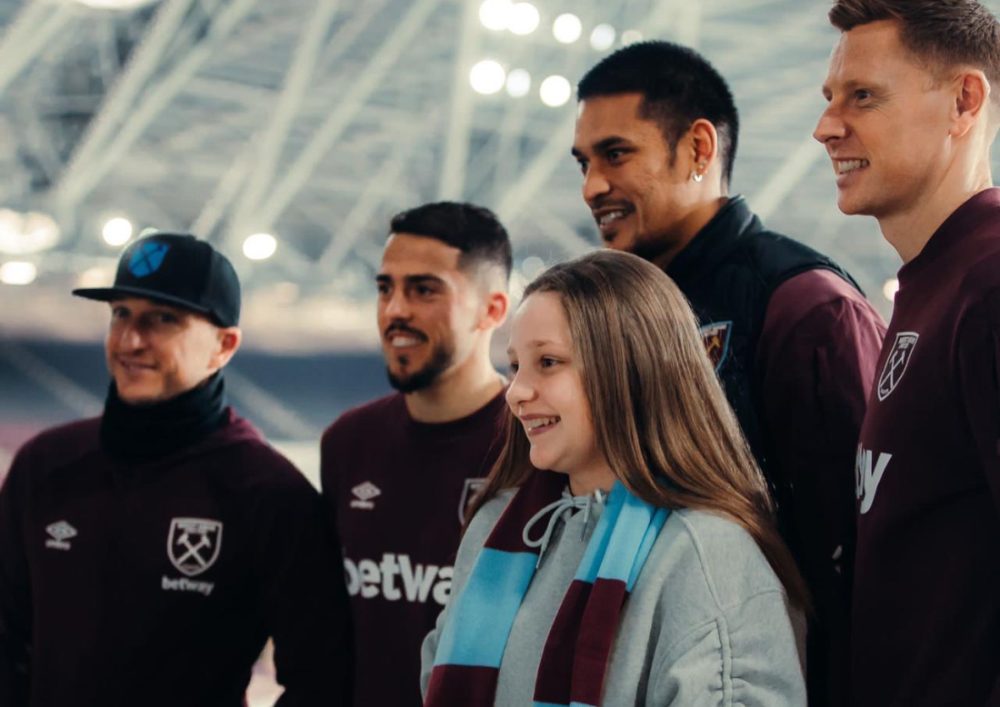 West Ham players having a picture taken with a child