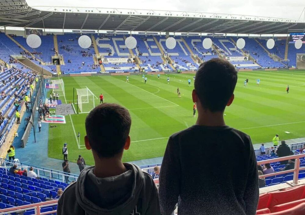 Kids silhouettes looking at the Reading FC stadium