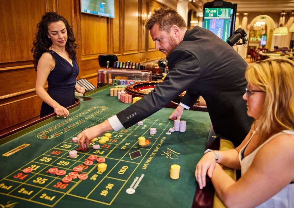 A man moving game chips on across a table